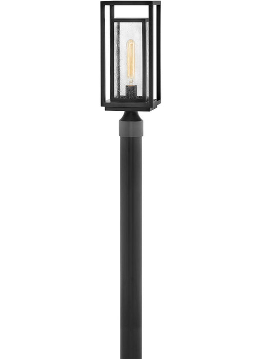 A traditional outdoor wall lantern with a black finish and clear seeded glass.