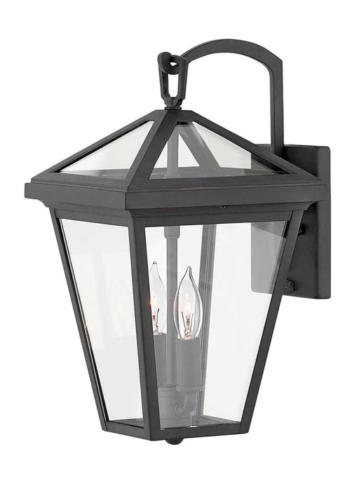 A traditional outdoor wall lantern with a matte black finish and clear seeded glass.