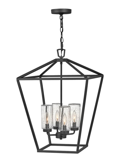 A traditional outdoor wall lantern with a matte black finish and clear seeded glass.