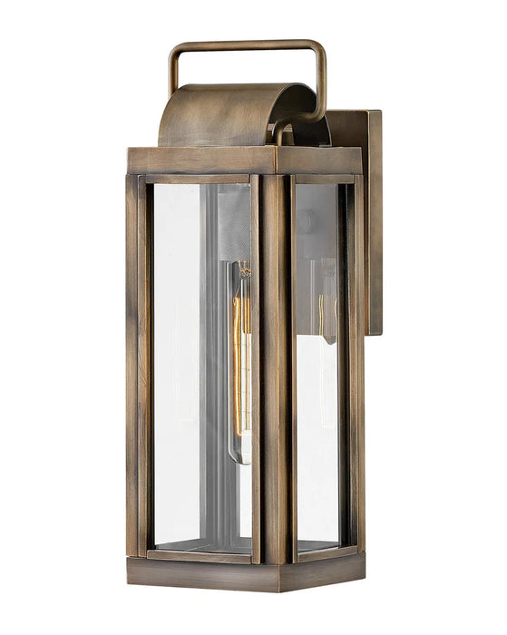 A traditional outdoor wall light with a bronze finish and clear seeded glass.