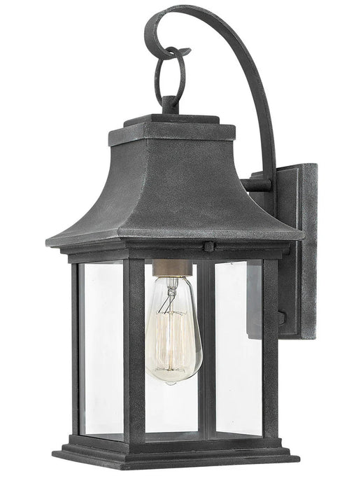 A traditional outdoor wall lantern with a dark bronze finish and clear seeded glass.