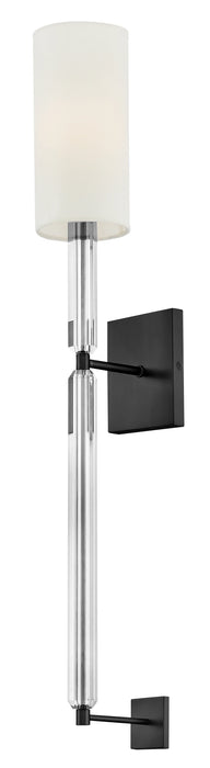 A contemporary ceiling fan with four black rectangular blades and a central cylindrical light.