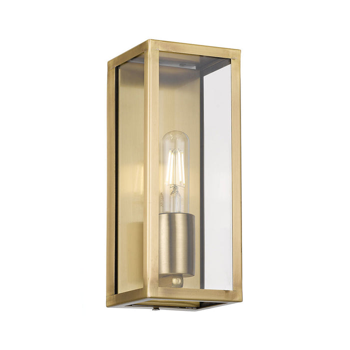 A modern outdoor wall light with an antique bronze finish and a clear cylindrical glass shade.