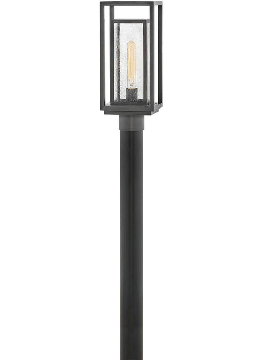 A traditional outdoor wall lantern with an oil-rubbed bronze finish and clear seeded glass.