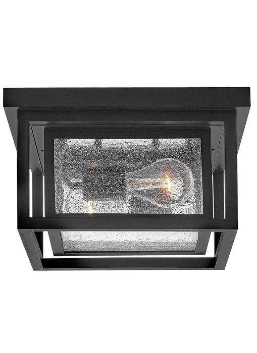 A traditional outdoor wall lantern with a black finish and clear seeded glass.