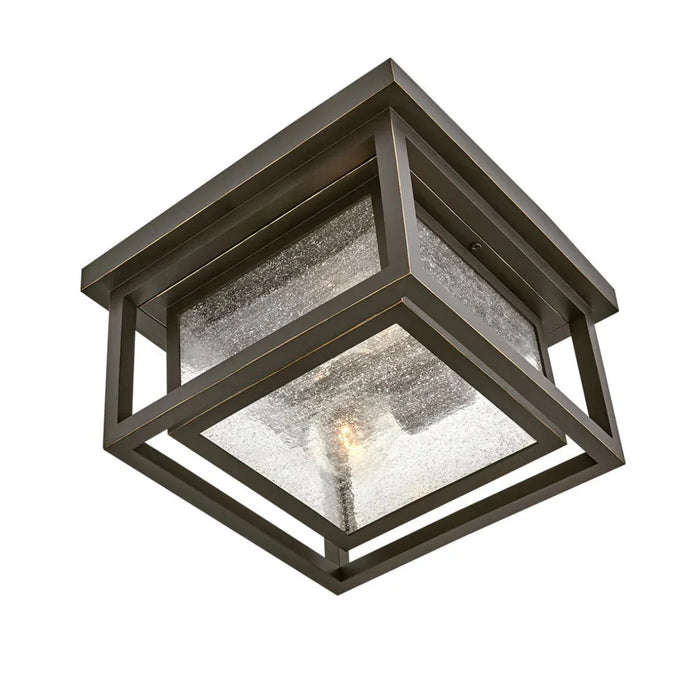 A close-up of a traditional outdoor wall lantern with an oil-rubbed bronze finish.