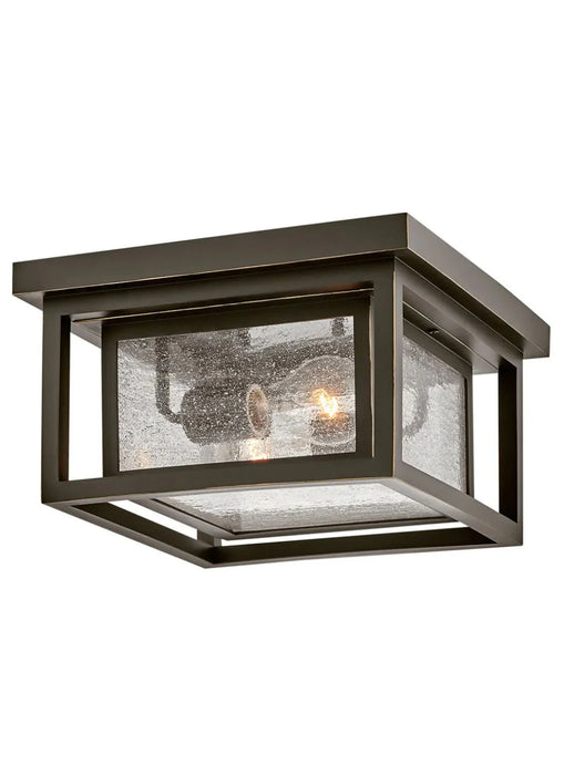A traditional outdoor wall lantern with an oil-rubbed bronze finish and clear seeded glass.