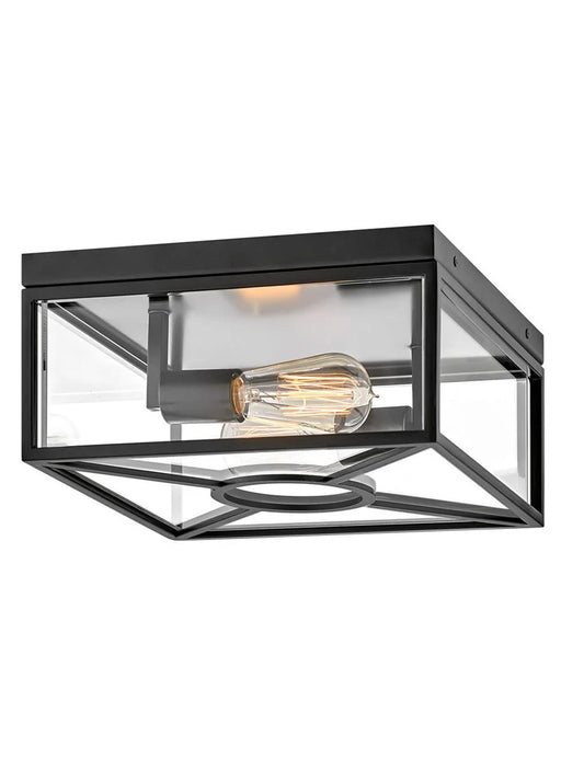 A modern outdoor wall light with a black finish and clear glass panels.