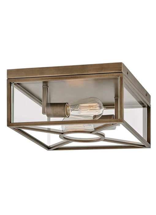 A modern outdoor wall light with a bronze finish and clear glass panels.