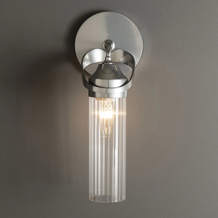 A side view of a modern ceiling fan with light wood-tone blades.