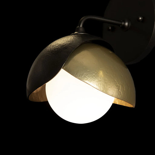 A close-up of a modern ceiling fan with an integrated LED light and a dark bronze finish.