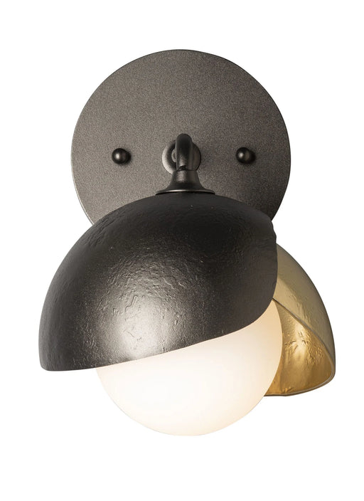 A modern ceiling fan with a large circular LED light and a dark bronze body.