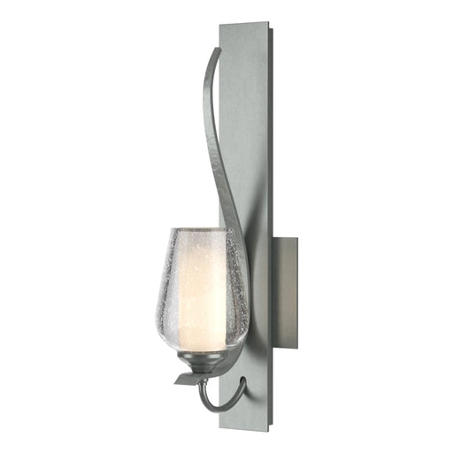 An angled view of a modern ceiling fan with dark wood-tone blades highlighting the light kit.