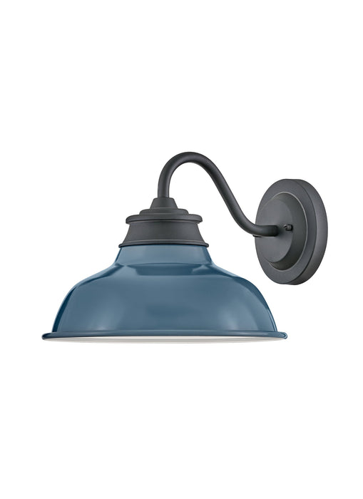 A modern outdoor wall light with a matte black finish and clear glass panels.