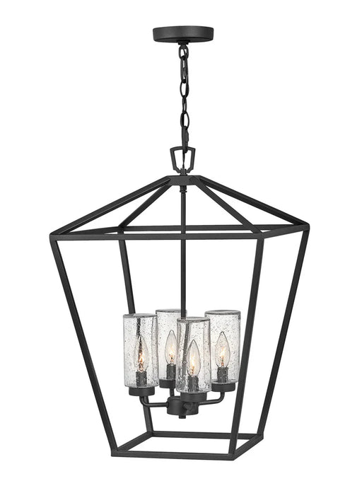 A traditional outdoor wall lantern with a matte black finish and clear seeded glass.