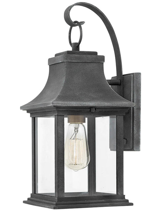 A traditional outdoor wall lantern with a dark bronze finish and clear seeded glass.