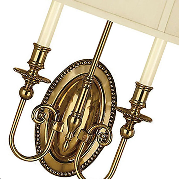 A close-up of a traditional bronze chandelier showing the candle-style lights.