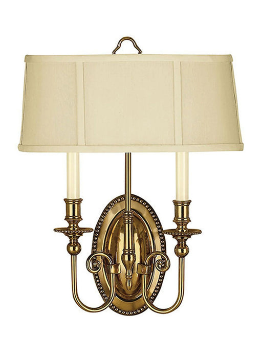 A traditional bronze chandelier with multiple candle-style lights arranged in a circular design.