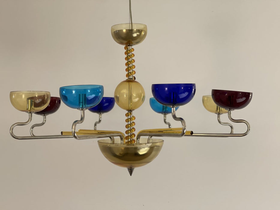 Modern black six-light linear pendant with spherical frosted glass shades, from a side angle.
