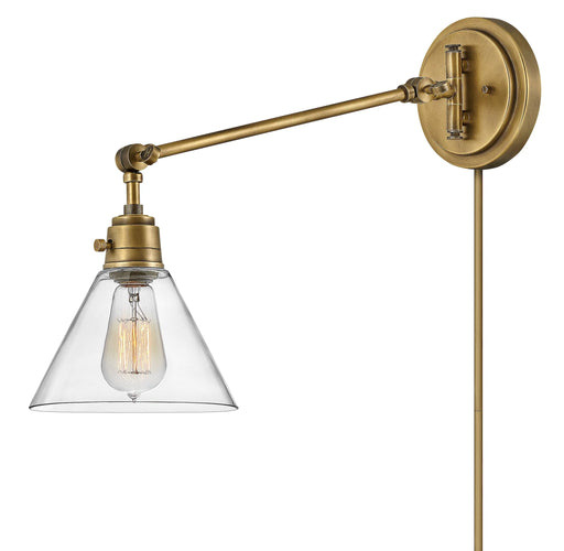 Heritage bronze pendant light with a single cylindrical clear glass shade and exposed bulb, angled view.