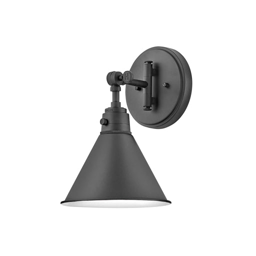 Black wall light with a cylindrical clear glass shade.