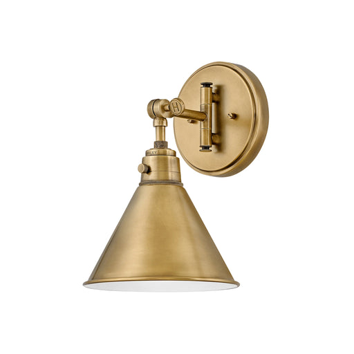 Heritage bronze wall light with a cylindrical clear glass shade.
