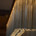 Large, modern wall sconce with a rectangular, perforated metal design, angled view.