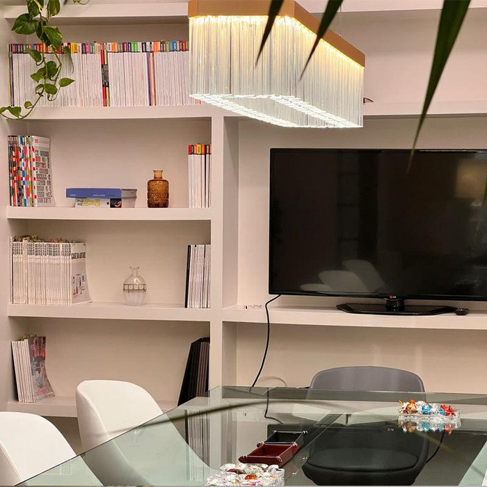 Large, modern wall sconce with a rectangular, perforated metal design.