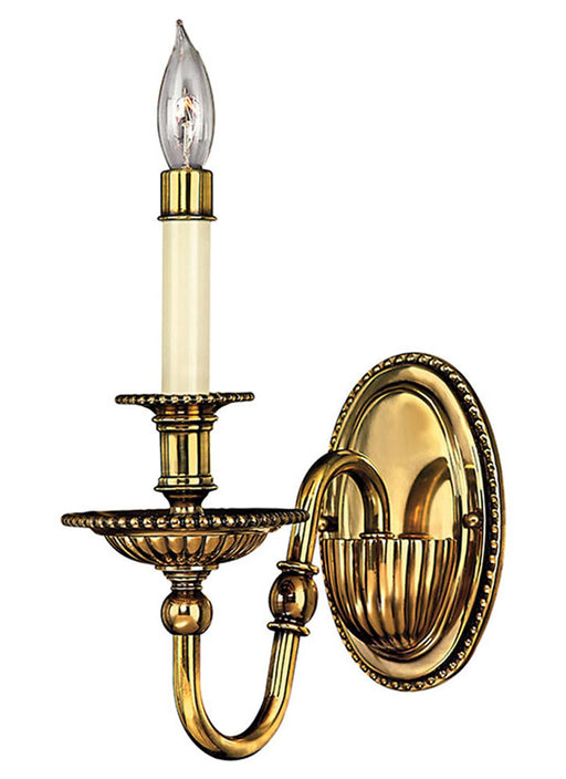 A traditional bronze chandelier with numerous candle-style lights arranged in two tiers.