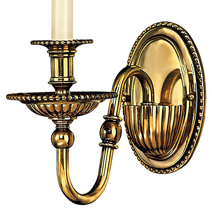 A large traditional bronze chandelier with two tiers of candle-style lights.