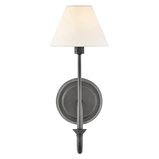A close-up of a small black modern wall light with a frosted glass panel.