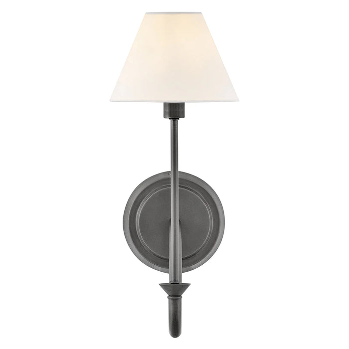 A close-up of a small black modern wall light with a frosted glass panel.