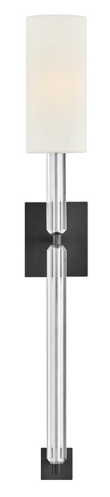 A close-up of a black ceiling fan showing the texture of the blades and light kit.