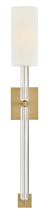 A close-up of a ceiling fan with light wood-tone blades showing the texture and light kit.