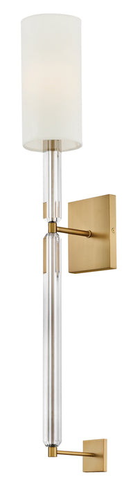 A contemporary ceiling fan with four light wood-tone rectangular blades and a central cylindrical light.