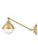 A satin brass linear pendant light with four clear glass shades viewed from a different angle.