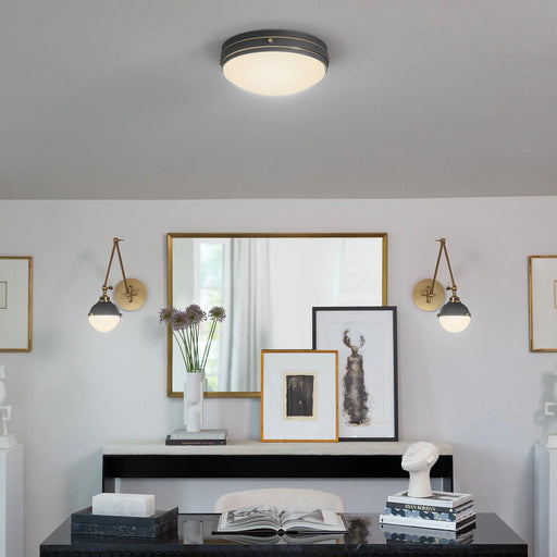 A dark bronze linear pendant light with clear glass shades illuminating a dining area.