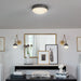 A dark bronze linear pendant light with clear glass shades illuminating a dining area.