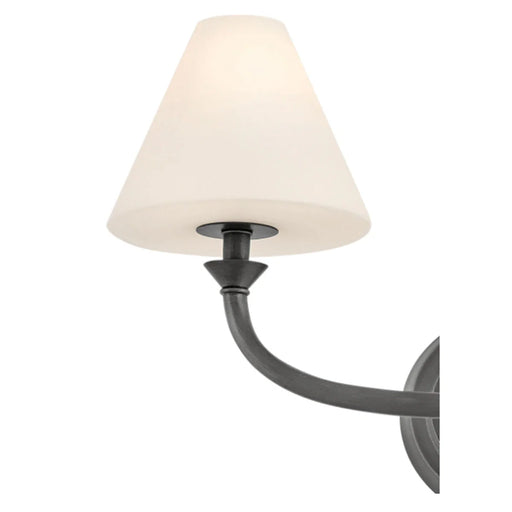 A close-up of a black open-cage wall light showcasing its linear details.
