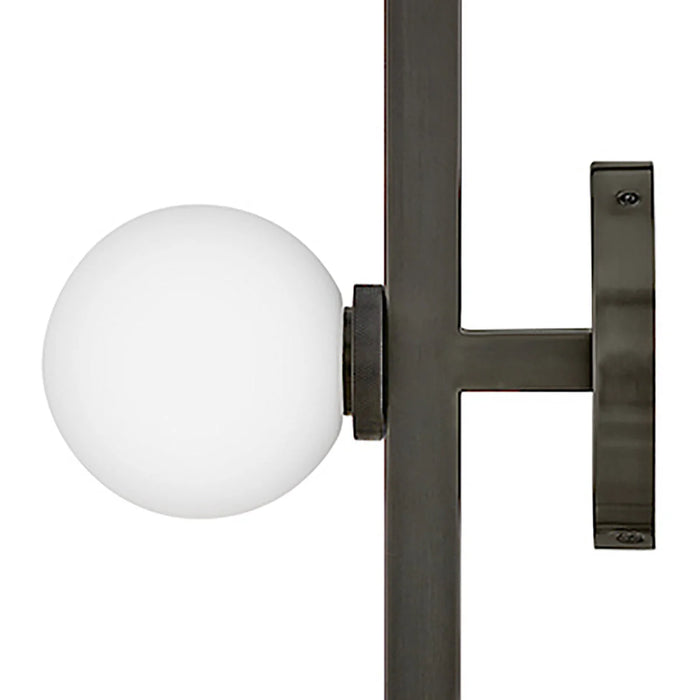 An angled view of a modern black outdoor wall lantern with seeded glass.