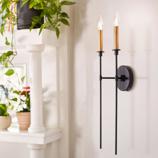 A black outdoor wall lantern with clear glass panels mounted on a residential exterior.