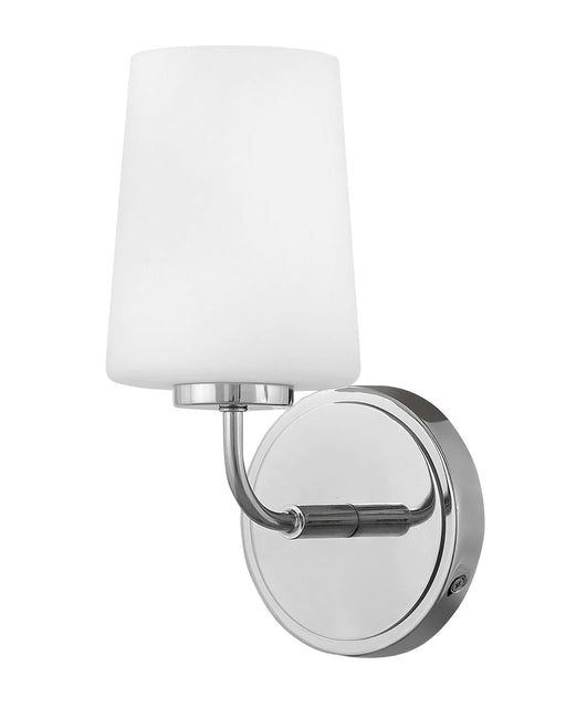 Polished chrome bathroom vanity light with three spherical white glass shades.