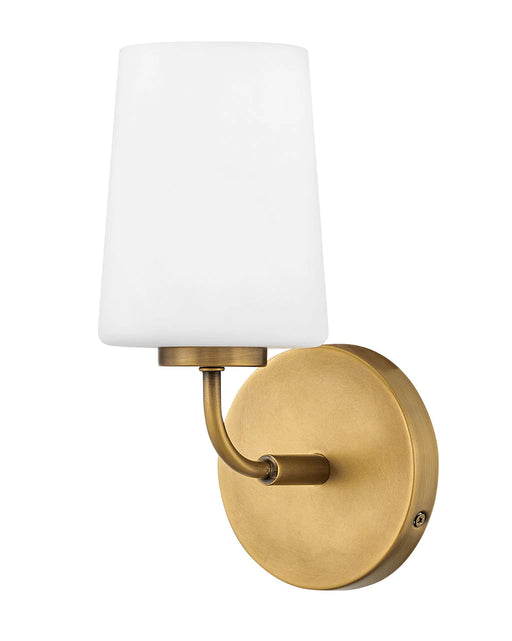Heritage bronze bathroom vanity light with three spherical white glass shades.