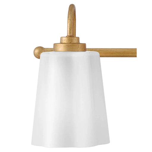A close-up view of a large architectural bronze outdoor sconce with a clear glass shade.