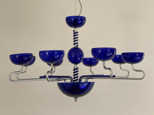 Modern black six-light linear pendant with spherical frosted glass shades, from a high angle.
