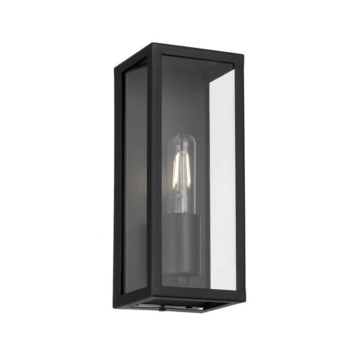 A modern outdoor wall light with a black finish and a clear cylindrical glass shade.