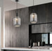 Black and smoky gray 14-light pendant with spherical frosted shades, illuminated.