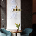 Large, modern wall sconce with a rectangular, metallic frame, angled view.