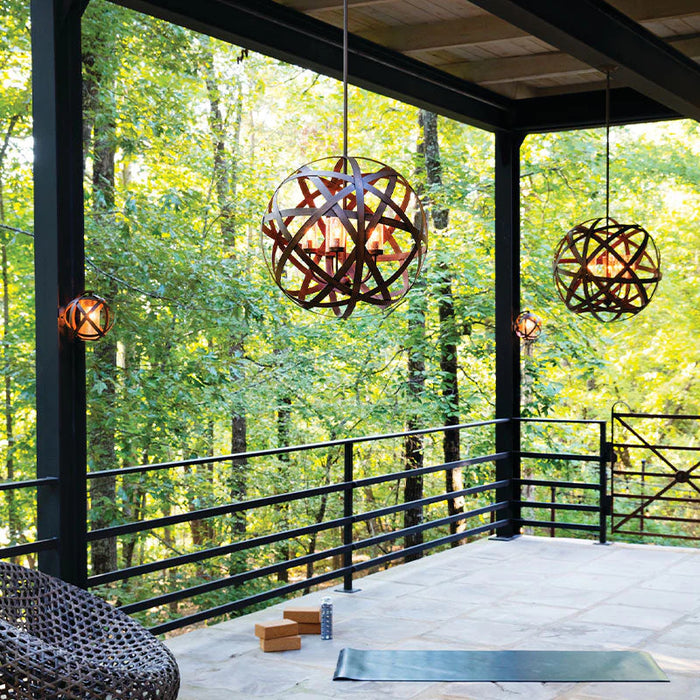 A close-up of a traditional bronze outdoor wall lantern with seeded glass.