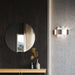 Large, modern wall sconce with a rectangular, metallic frame, side view.
